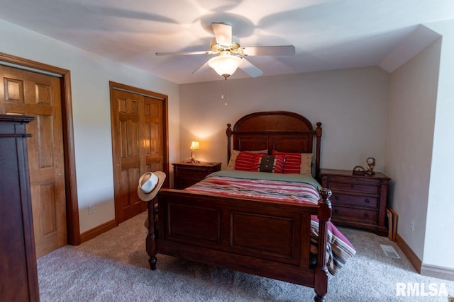 bedroom featuring a closet, light colored carpet, and ceiling fan