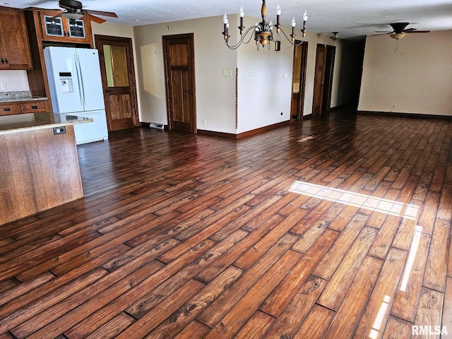 kitchen featuring dark hardwood / wood-style floors, white fridge with ice dispenser, and ceiling fan with notable chandelier