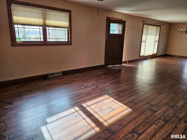 spare room with dark wood-type flooring