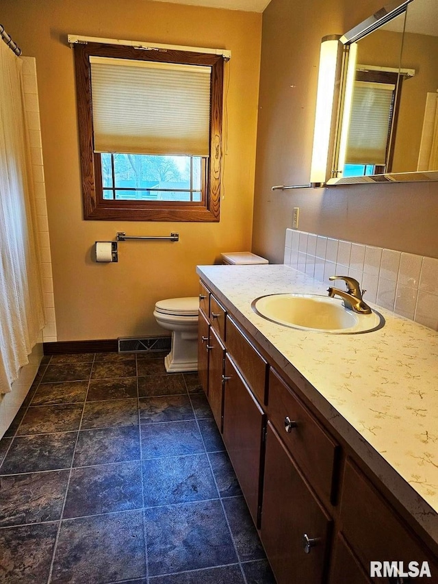 bathroom with vanity and toilet