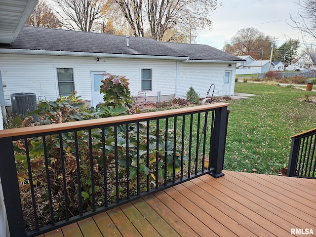 wooden deck with central AC unit and a lawn