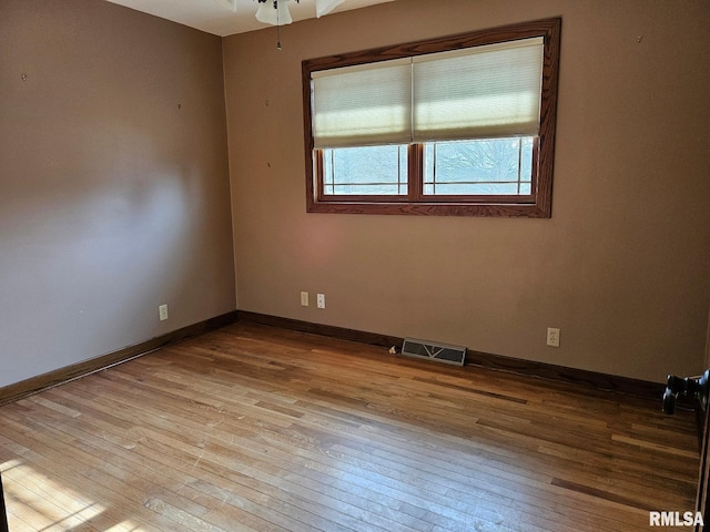 empty room with light hardwood / wood-style flooring