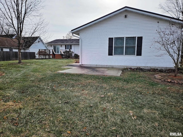 back of property featuring a patio area, a yard, and a wooden deck