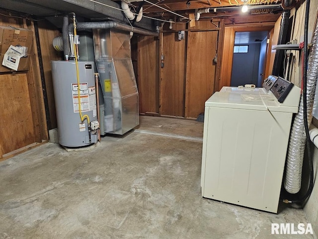 basement with independent washer and dryer, gas water heater, and wooden walls