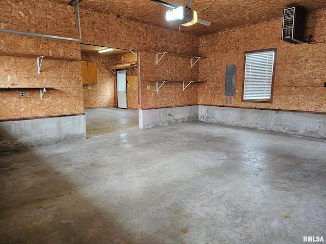 garage featuring electric panel and a garage door opener