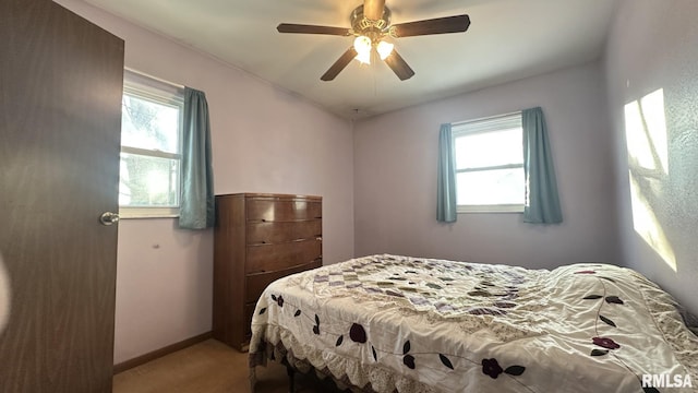 carpeted bedroom featuring ceiling fan