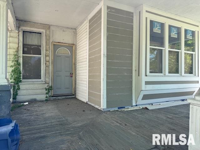 view of exterior entry with a porch