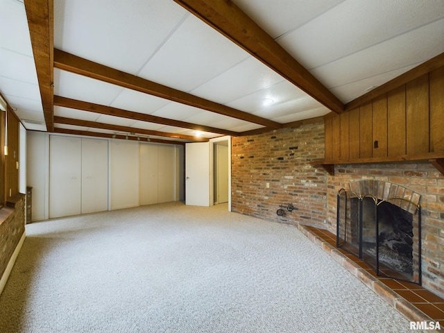 unfurnished living room with a fireplace, beam ceiling, and light carpet