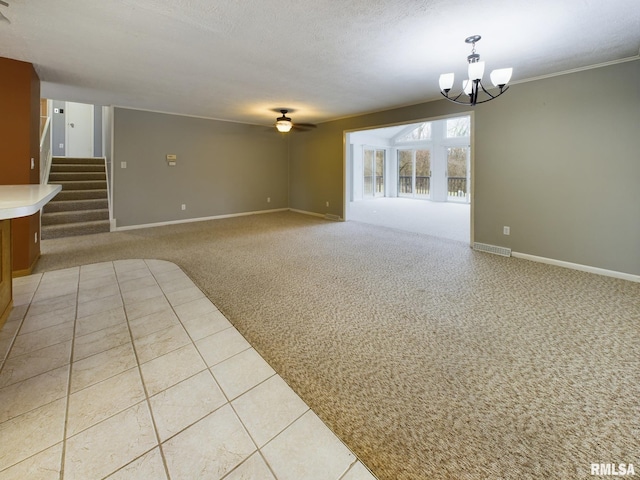 interior space with ceiling fan with notable chandelier and a textured ceiling