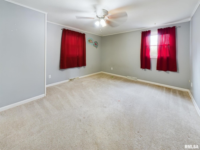 carpeted empty room featuring ceiling fan and crown molding