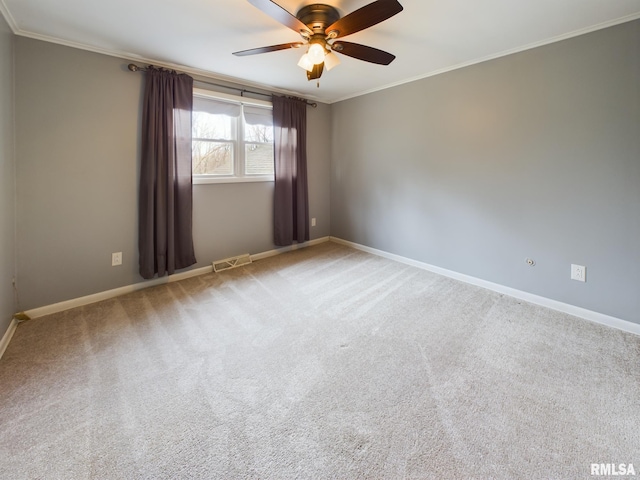 carpeted empty room featuring ceiling fan and ornamental molding