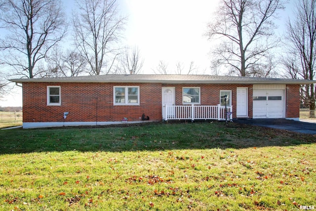 single story home with a garage, a front yard, and covered porch