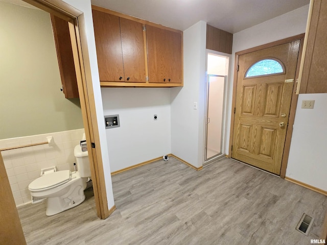 laundry room featuring tile walls, hookup for a washing machine, light hardwood / wood-style floors, and hookup for an electric dryer