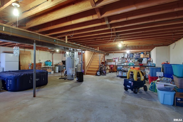 basement with white refrigerator and water heater