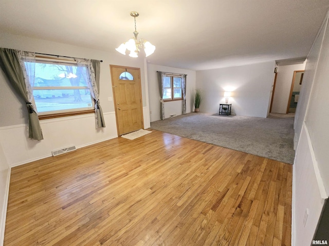 entrance foyer featuring a notable chandelier and light hardwood / wood-style floors