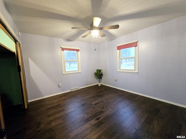 interior space featuring ceiling fan, dark hardwood / wood-style flooring, and a wealth of natural light