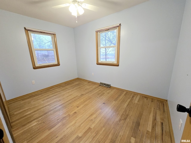 spare room featuring ceiling fan and light wood-type flooring