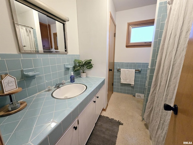 bathroom with tile walls and vanity