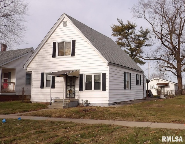 bungalow-style home with a front lawn