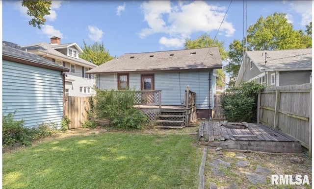 back of house featuring a yard and a wooden deck