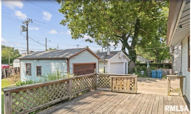 wooden terrace with a garage and an outbuilding