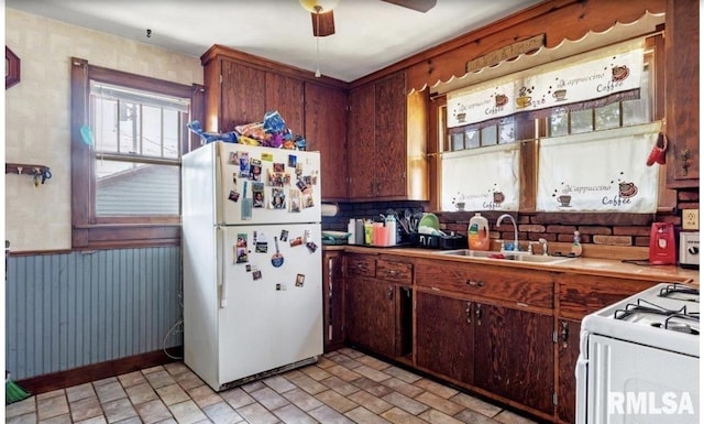 kitchen with ceiling fan, white appliances, and sink