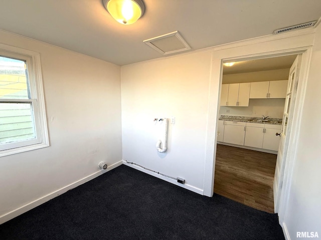 laundry room featuring dark hardwood / wood-style flooring and sink