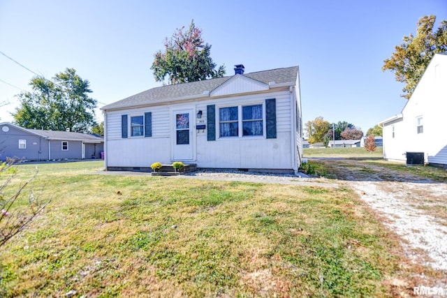 bungalow-style house with a front yard