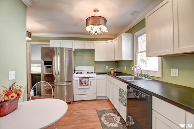 kitchen with hanging light fixtures, sink, stainless steel refrigerator with ice dispenser, black dishwasher, and white range with gas stovetop