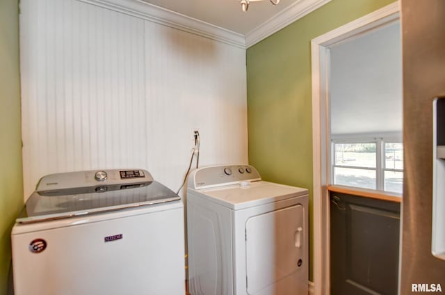 clothes washing area with ornamental molding and washing machine and clothes dryer