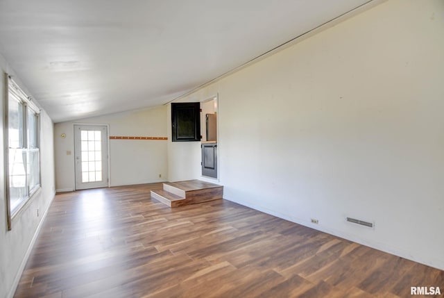 unfurnished living room featuring wood-type flooring and vaulted ceiling