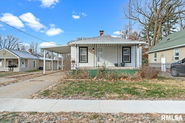 bungalow-style home featuring a carport and covered porch