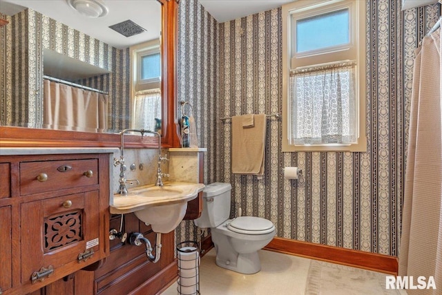 bathroom with tile patterned flooring and toilet