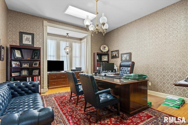 office area featuring hardwood / wood-style flooring and an inviting chandelier