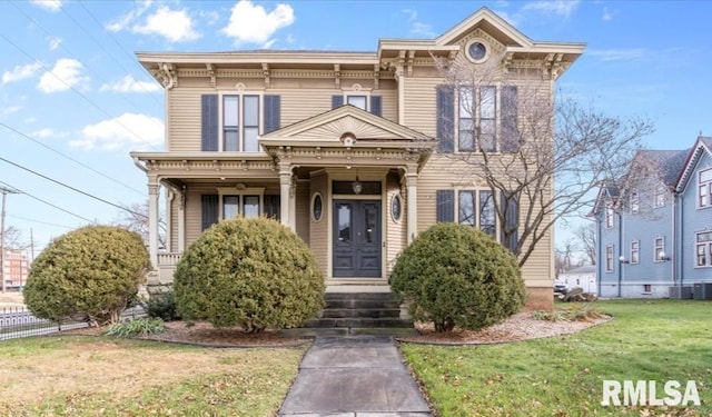 italianate-style house featuring a front yard and central air condition unit