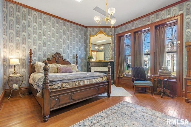 bedroom with light hardwood / wood-style flooring, ornamental molding, and a notable chandelier