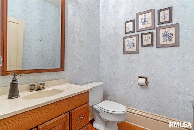 bathroom featuring hardwood / wood-style floors, vanity, and toilet