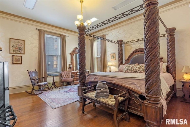 bedroom with a chandelier, wood-type flooring, and crown molding