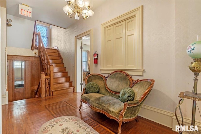 sitting room featuring a notable chandelier and hardwood / wood-style flooring