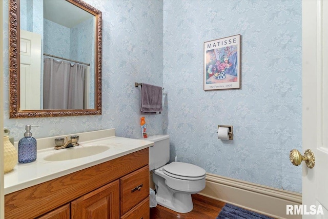 bathroom featuring hardwood / wood-style floors, vanity, and toilet