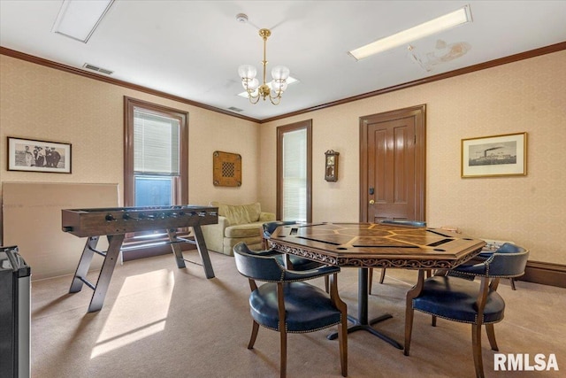 dining area featuring light colored carpet, a chandelier, and ornamental molding