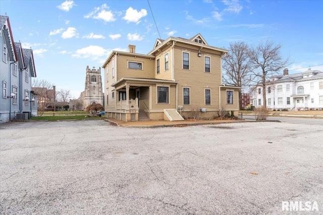 rear view of property featuring central AC unit