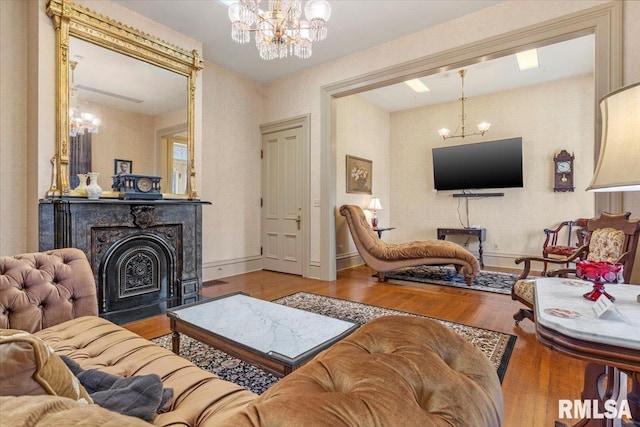 living room featuring a chandelier and hardwood / wood-style floors