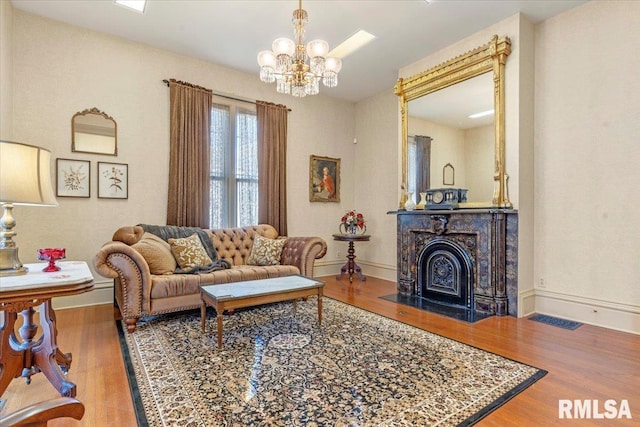 living room featuring wood-type flooring and a notable chandelier