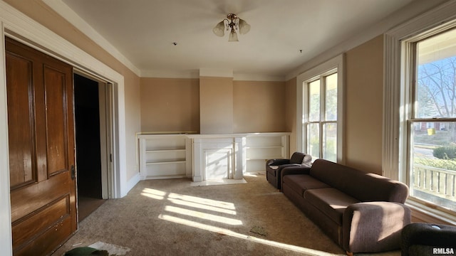 sitting room with carpet, a wealth of natural light, and crown molding