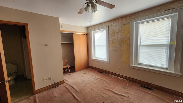 unfurnished bedroom with carpet, a closet, and ceiling fan