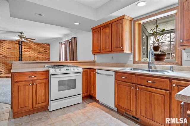 kitchen with kitchen peninsula, white range, ceiling fan, sink, and dishwasher