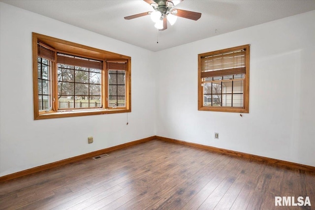 spare room featuring dark hardwood / wood-style flooring and ceiling fan