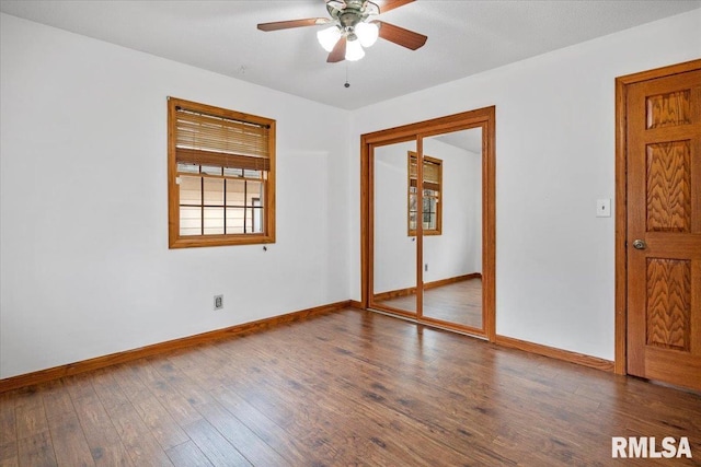 unfurnished room with ceiling fan and dark wood-type flooring