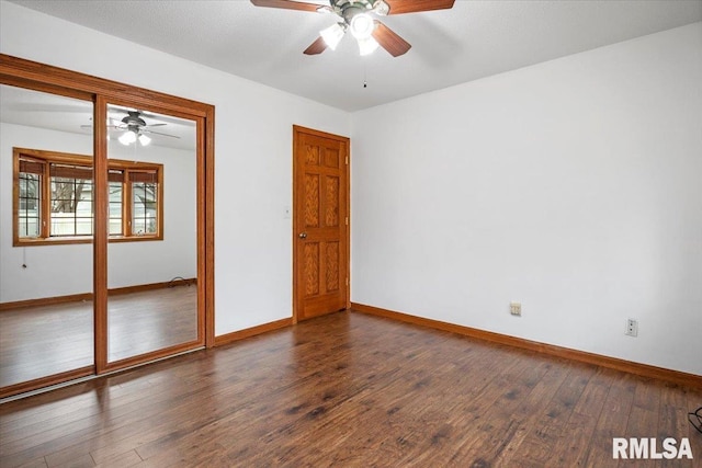 empty room featuring dark hardwood / wood-style floors and ceiling fan